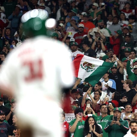 Fans celebrate as Julian Ornelas of Team Mexico runs the bases after hitting a two-run home run against Brazil.