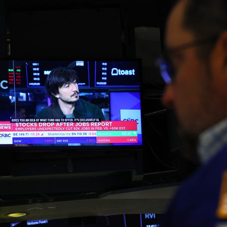 NEW YORK, NEW YORK - MARCH 06: Financial news is displayed as traders work on the floor of the New York Stock Exchange during morning trading on March 06, 2026 in New York City. Stocks continue to tumble with all three major indexes continuing to dip with the Dow Jones losing nearly 800 points at opening as oil prices raise due to concerns of the war with Iran and a weak jobs report release. (Photo by Michael M. Santiago/Getty Images)