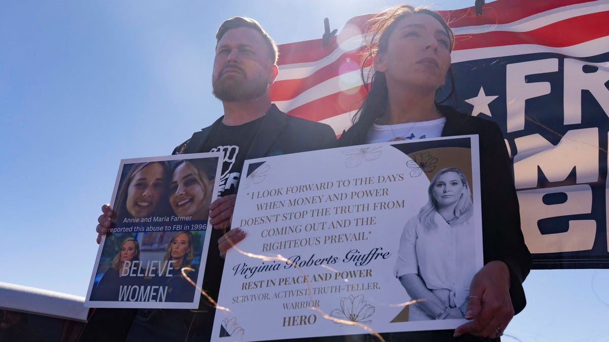 Sky Roberts, brother of Virginia Roberts Giuffre, and Amanda Roberts, sister in law of Virginia Roberts Giuffre, hold signs outside Zorro Ranch, a property formerly owned by Jeffrey Epstein, on International Women’s Day near Stanley, N.M., March 8, 2026.