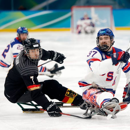 MILAN, ITALY - MARCH 09: David Eustace #37 of Team United States is challenged by Leopold Reimann #7 of Team Germany during the Para Ice Hockey Preliminary Round Match between Team Germany and Team United States on day three of the Milano Cortina 2026 Winter Paralympic Games at Milano Santagiulia Ice Hockey Arena on March 09, 2026 in Milan, Italy. (Photo by Darrian Traynor/Getty Images)