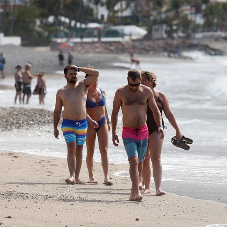 Tourists spend time at a beach days after a series of blockades and attacks by organized crime following a military operation in which drug cartel leader Nemesio Oseguera, known as "El Mencho," was killed, in Puerto Vallarta, Mexico, Feb. 24, 2026.