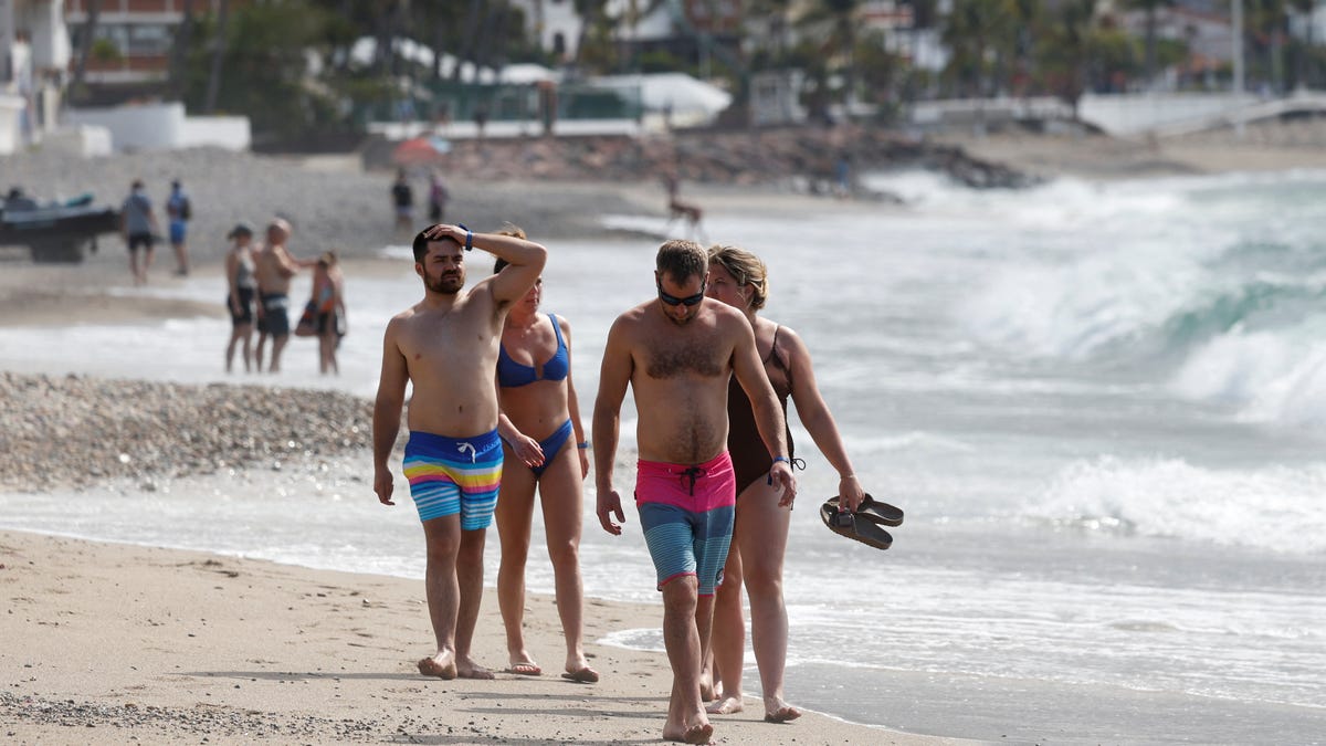 Tourists spend time at a beach days after a series of blockades and attacks by organized crime following a military operation in which drug cartel leader Nemesio Oseguera, known as "El Mencho," was killed, in Puerto Vallarta, Mexico, Feb. 24, 2026.