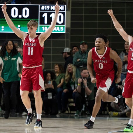 Miami RedHawks forward Almar Atlason (11), Miami RedHawks guard Eian Elmer (0) and Miami RedHawks guard Peter Suder (5) react after defeating Ohio Bobcats in the MAC conference final game at the Convocation Center in Athens, Ohio, on Friday, March 6, 2026.
