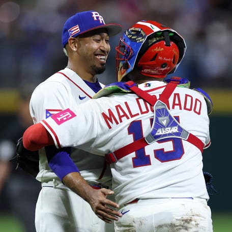 Edwin Diaz and Martin Maldonado celebrate the win against Cuba.