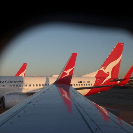 A Qantas logo is visible on the tail of an aeroplane at an airport in Sydney, Australia, September 18, 2025.