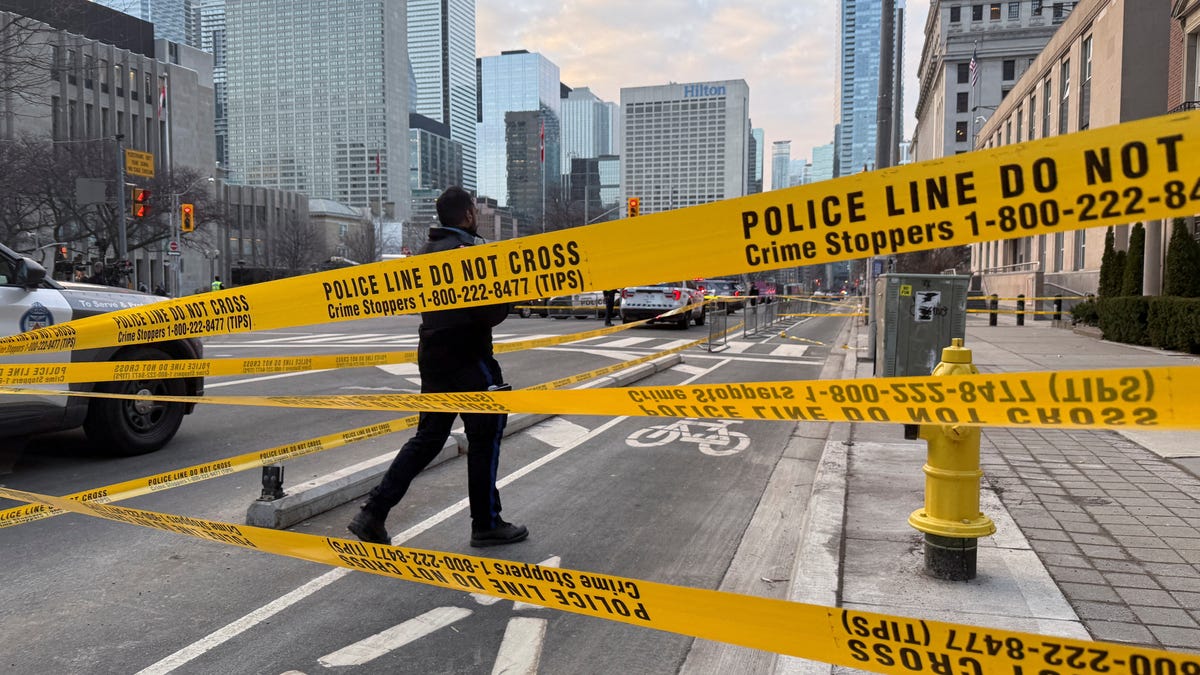 A member of law enforcement personnel works at the scene outside the U.S. Consulate after shots were fired in Toronto, Canada, March 10, 2026.