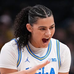 UCLA center Lauren Betts (51) and guard Kiki Rice (1) high-five guard Gianna Kneepkens (8) on March 8, 2026, during the Big Ten Tournament Championship game at Gainbridge Fieldhouse in Indianapolis.