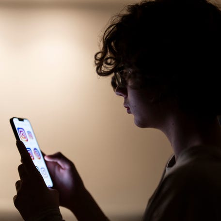 Teenager Bruno scrolls through social media on his phone in Madrid on Feb. 4, 2026.