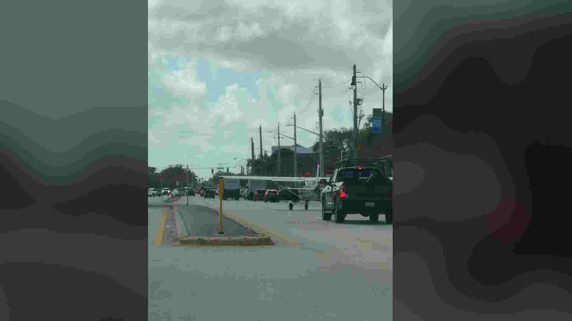 Video shows small plane moving with busy road traffic