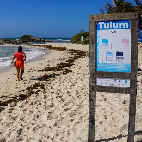 A woman walks along the shore of the beach before Hurricane Beryl's arrival in Tulum, Quintana Roo State, Mexico, on July 4, 2024.