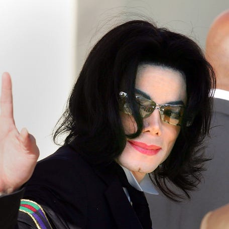 Michael Jackson waves as he arrives for his trial at the Santa Barbara County courthouse on May 2, 2005 in Santa Maria, California.