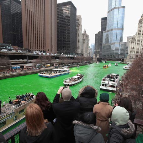 CHICAGO, IL - MARCH 17: Visitors take pictures of the Chicago River shortly after it was dyed green in celebration of St. Patrick's Day on March 17, 2018 in Chicago, Illinois. Dyeing the river has been a St. Patrick's Day tradition in the city since 1962. (Photo by Scott Olson/Getty Images)