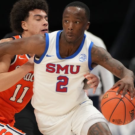 SMU guard Boopie Miller (2) dribbles the ball as Syracuse guard Naithan George (11) defends during the 2026 ACC tournament game at Spectrum Center in Charlotte, N.C.