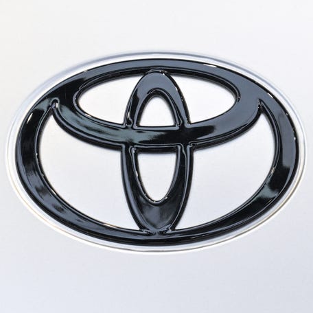 A Toyota logo is seen on a hybrid Toyota Camry model on display during the 21st Shanghai International Automobile Industry Exhibition at the National Exhibition and Convention Center in Shanghai on April 23, 2025.