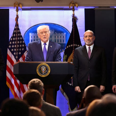 President Donald Trump, flanked by Secretary of Commerce Howard Lutnick, Trade Representative Jamieson Greer and Solicitor General John Sauer, speaks during a press briefing at the White House, following the Supreme Court's ruling that Trump had exceeded his authority when he imposed tariffs, in Washington, D.C., on Feb. 20, 2026.