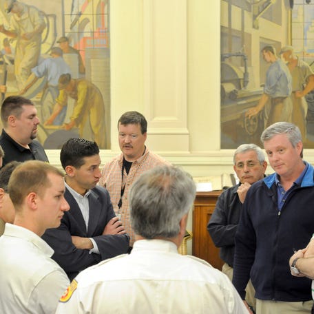 The murals at Norton Hall served as a backdrop to this May 2013 meeting of an emergency planning group.