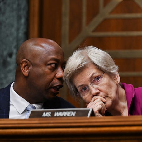 Chairman Tim Scott (R-SC) speaks with Ranking Member Elizabeth Warren (D-MA) during a Senate Banking, Housing and Urban Affairs Committee confirmation hearing in February 2025.