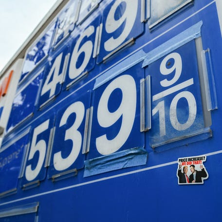 A sticker featuring U.S. President Donald Trump and Elon Musk on a board displaying gas prices amid the U.S.-Israeli conflict with Iran, in Washington, D.C., U.S., March 11, 2026. REUTERS/Annabelle Gordon