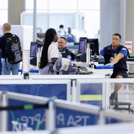 Transportation Security Administration agents check in passengers in Houston on March 10, 2026. Nearly a month into a partial government shutdown that leaves TSA agents unpaid, the lines at airport security are getting longer and longer. The wait times and pay changes are a result of a partial shutdown that began in mid-February after Congress failed to pass funding for the Department of Homeland Security, which oversees TSA. Congressional Democrats say that after two U.S. citizens were shot dead   by federal officers in Minneapolis, they need reforms cemented into law before agreeing to fund DHS, which also oversees immigration and border security officers.