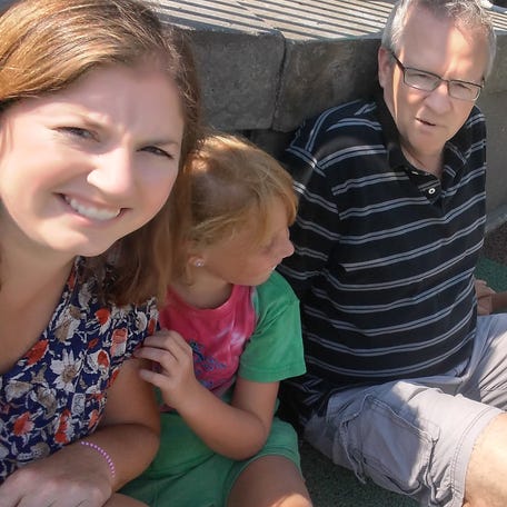 Nicole Russell, left, with her father, John Hanson, and her children at a park in 2016.