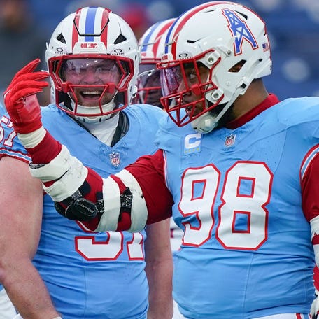 Tennessee Titans defensive tackle Jeffery Simmons (98) talks some trash after stopping Houston Texans running back Joe Mixon (28) during the first quarter at Nissan Stadium in Nashville, Tenn., Sunday, Jan. 5, 2025.