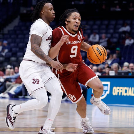 Oklahoma guard Nijel Pack drives to the basket against Texas A&M guard Josh Holloway during the second round of the 2026 SEC tournament at Bridgestone Arena in Nashville, Tenn.