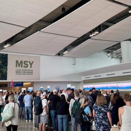 Passengers line up at Louis Armstrong New Orleans International Airport, in Kenner, Louisiana on March 8, 2026.