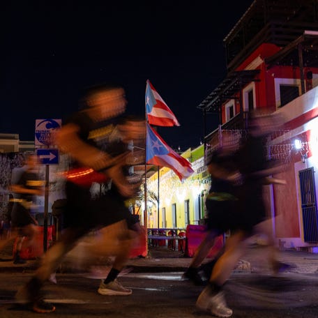 Puerto Rican flags wave as soldiers assigned to the U.S. Army Reserve's 1st Mission Support Command jog along a public route during the annual Caribbean Army Week in San Juan, Puerto Rico, January 9, 2026. REUTERS/Ricardo Arduengo