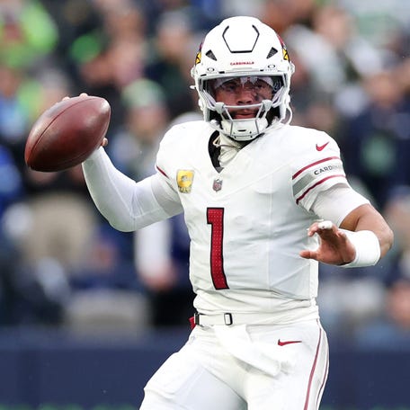 Kyler Murray #1 of the Arizona Cardinals looks to pass as Devon Witherspoon #21 of the Seattle Seahawks defends during the second quarter at Lumen Field on November 24, 2024 in Seattle, Washington.