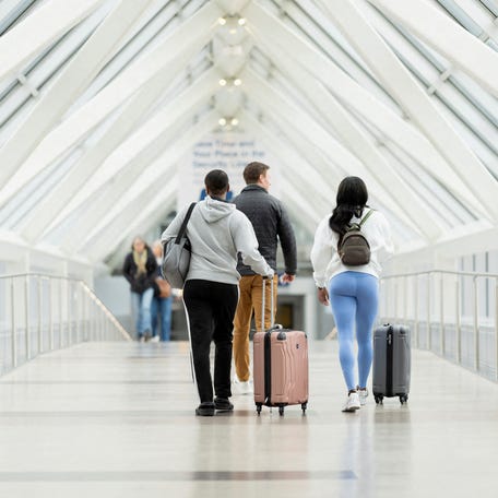 Travelers leave Minneapolis Saint Paul International Airport in Minneapolis, Minnesota, U.S., November 7, 2025.