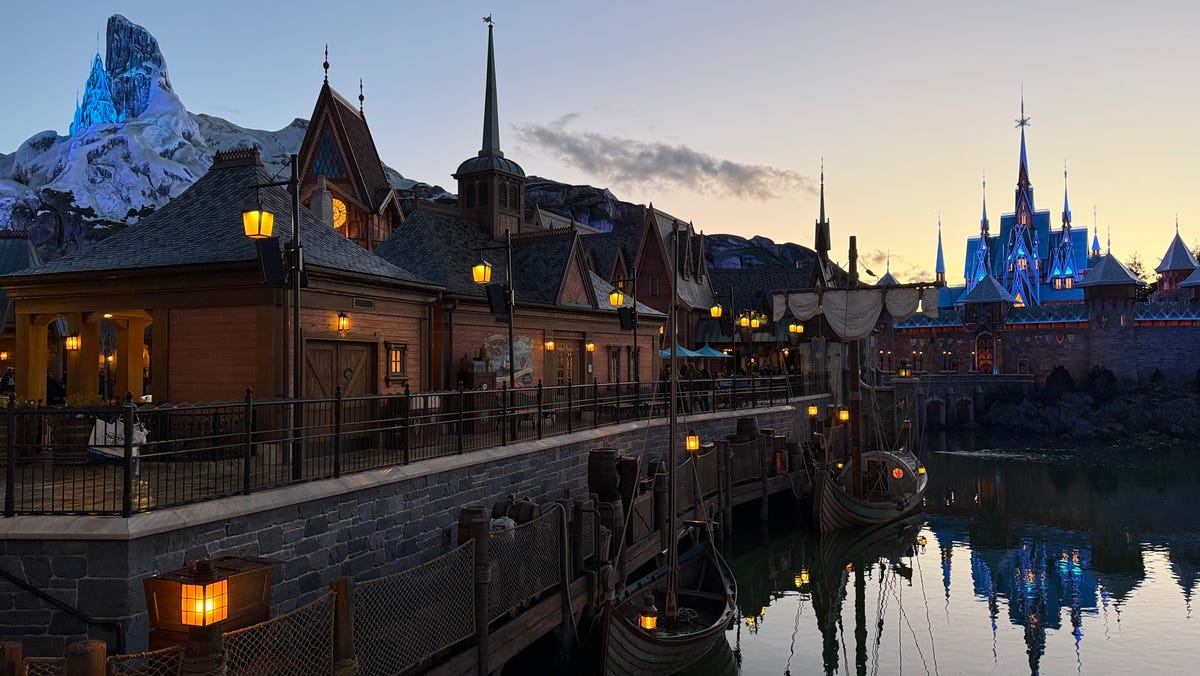 The World of Frozen begins to glow as night falls at Disney Adventure World.