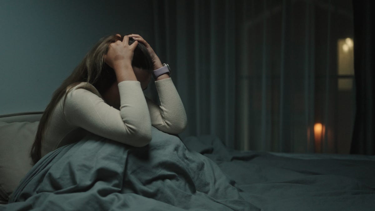 Young woman depression and anxiety on the bed at night.