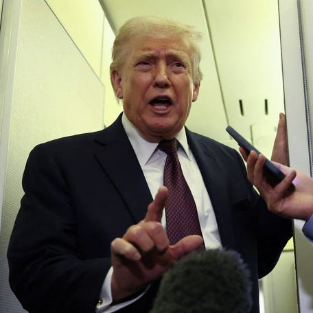 President Donald Trump speaks to reporters aboard Air Force One on a flight back to Washington, DC, on March 15, 2026.