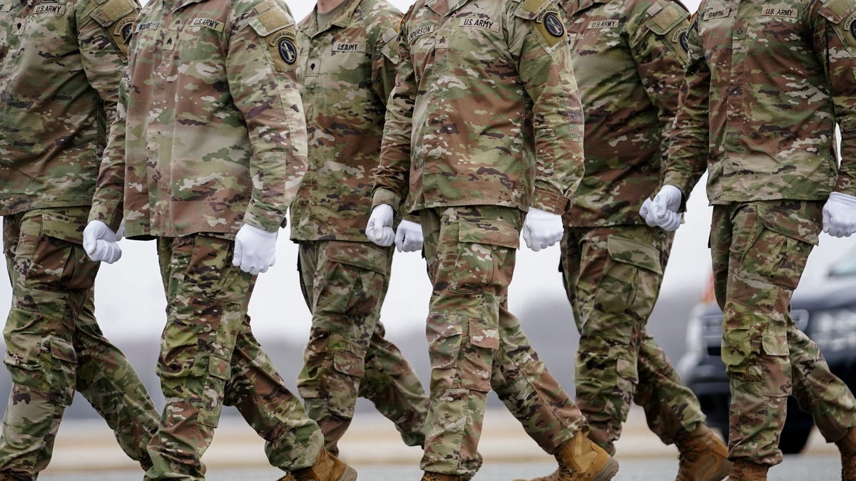 Members of the military walk during a dignified transfer of the remains of six U.S. Army service members of the 103rd Sustainment Command, who were killed in Kuwait, Major Jeffrey O'Brien, Capitain Cody Khork, Chief Warrant Officer 3 Robert Marzan, Sergeant 1st Class Nicole Amor, Sergeant 1st Class Noah Tietjens and Sergeant Declan Coady, amid the U.S.-Israeli conflict with Iran, at Dover Air Force Base in Dover, Delaware, U.S.,   March 7, 2026. REUTERS/Nathan Howard