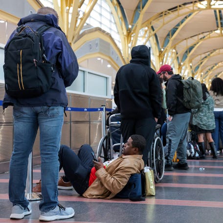 Passengers wait in a check-in line at Ronald Reagan Washington National Airport, as the Department of Homeland Security (DHS) continues to go unfunded, in Arlington, Virginia, U.S., March 16, 2026.