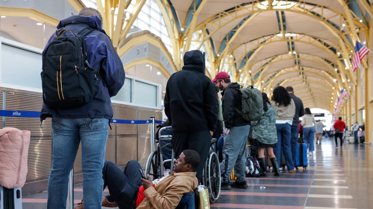 Passengers wait in a check-in line at Ronald Reagan Washington National Airport, as the Department of Homeland Security (DHS) continues to go unfunded, in Arlington, Virginia, U.S., March 16, 2026.