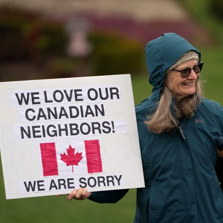A person holds a pro-Canada sign during a "Peace, Love, and a Handshake" solidarity rally at the Peace Arch Border Crossing at the Canada-U.S. border in Blaine, Washington, on April 6, 2025.
