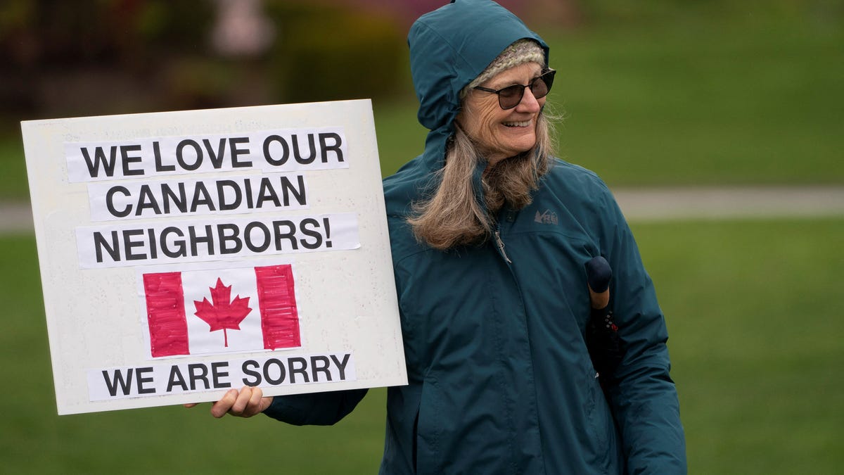 A person holds a pro-Canada sign during a "Peace, Love, and a Handshake" solidarity rally at the Peace Arch Border Crossing at the Canada-U.S. border in Blaine, Washington, on April 6, 2025.