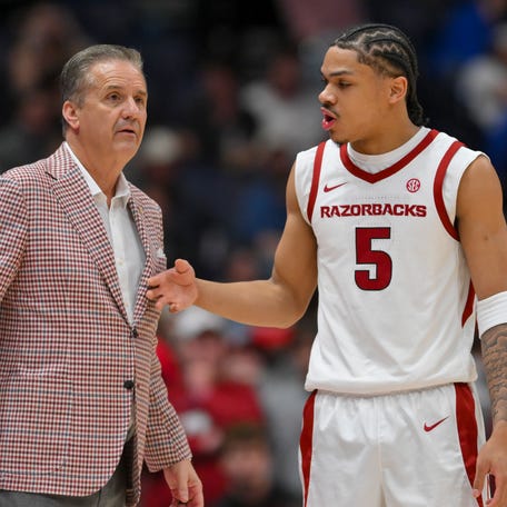 Arkansas Razorbacks head coach John Calipari talks with guard Darius Acuff Jr. (5) during a time out against the Oklahoma Sooners during the first half at Bridgestone Arena.