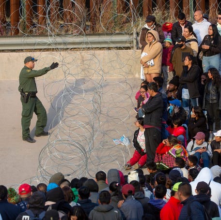 Migrants crossed the Rio Grande and approach the Texas National Guard to enquire when they will be allowed to be processed by Customs and Border Protection to seek asylum in El Paso, Texas on Dec. 20, 2022