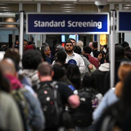 Travelers wait in line at a TSA security checkpoint at George Bush Intercontinental Airport in Houston, Texas on March 20, 2026.