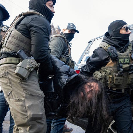 Aliya Rahman is carried by federal agents after being pulled from her vehicle following an immigration raid that led to the detainment of two Hispanic youths and multiple observers, days after an ICE agent fatally shot Renee Nicole Good, in Minneapolis, Minnesota, U.S., January 13, 2026.
