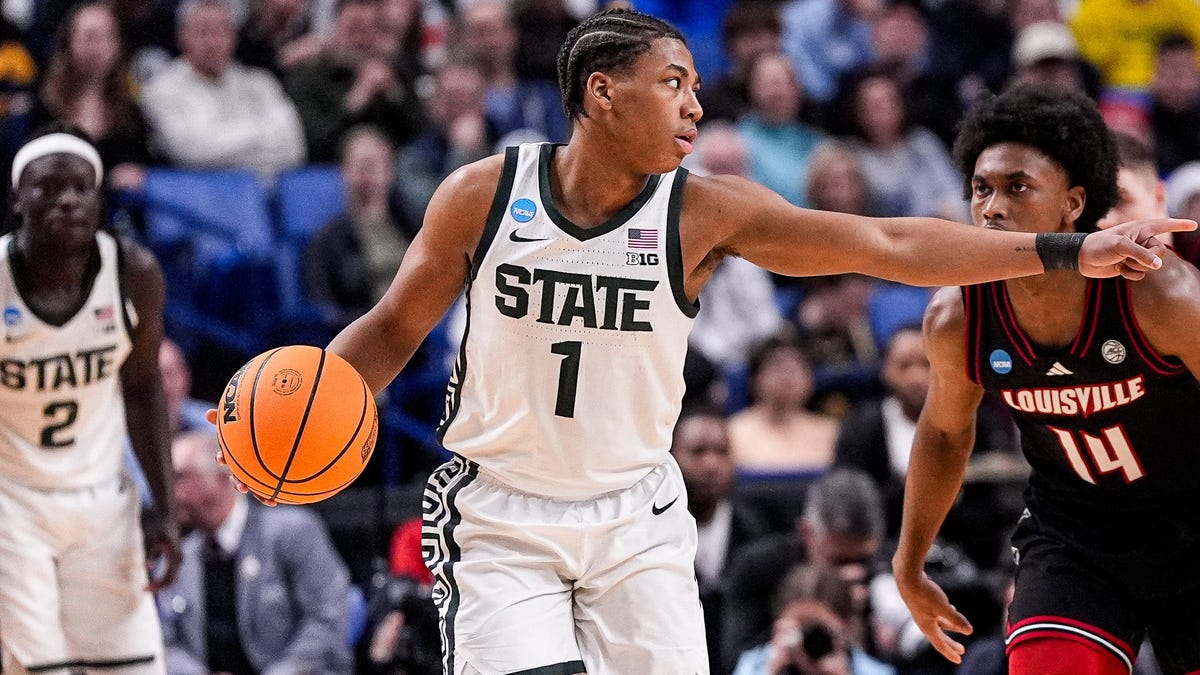 Michigan State guard Jeremy Fears Jr. (1) looks to pass against Louisville guard Adrian Wooley (14) during the 2026 NCAA men's tournament at KeyBank Center in Buffalo, N.Y.