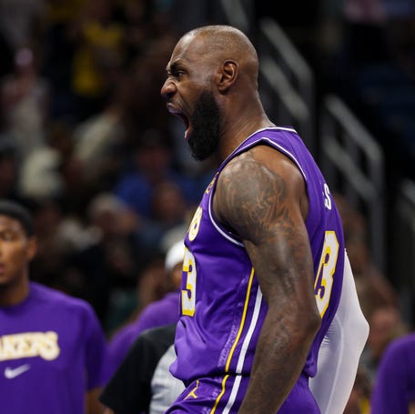 Los Angeles Lakers forward LeBron James reacts after dunking the ball against the Orlando Magic in the first quarter at Kia Center.