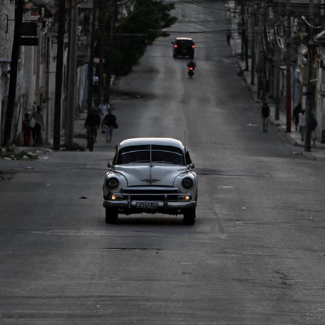 A vintage car drives along an empty street in Havana, Cuba, as the nation begins efforts to restore power after its grid collapsed for the second time in a week.