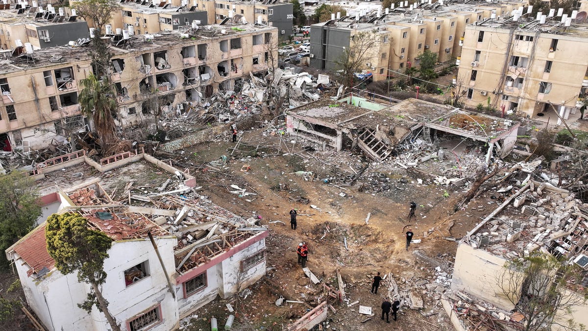 A drone view shows damage in a residential neighborhood following Iranian missile strikes in Dimona, southern Israel, on March 22, 2026.