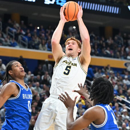 Michigan forward Oscar Goodman (5) shoots the ball while defended by Saint Louis guard Kellen Thames (0) and guard Amari McCottry (4) during a second round of the 2026 NCAA men's tournament at Keybank Center in Buffalo, N.Y.