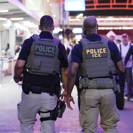 ICE agents walk through a long line of travelers at Atlanta Hartsfield-Jackson International Airport on March 23, 2026 in Atlanta, Georgia. The travel disruptions continue as hundreds of TSA agents quit or work without pay during a partial government shutdown. President Donald Trump said ICE agents will be deployed to airports on Monday, with border czar Tom Homan in charge of the effort.