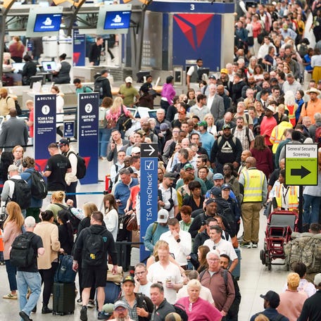 Travelers stand in long lines at Atlanta Hartsfield-Jackson International Airport on March 23, 2026 in Atlanta. The travel disruptions continue as hundreds of TSA agents quit or work without pay during a partial government shutdown.