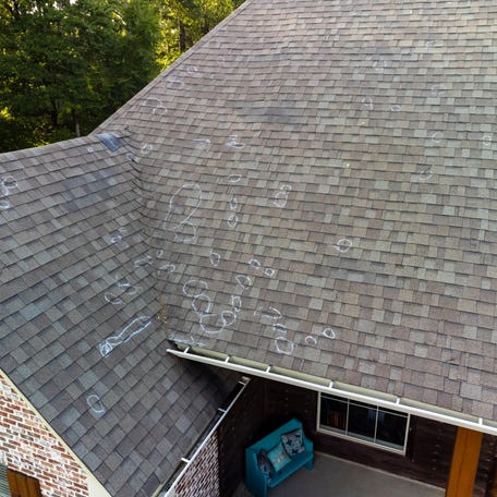 Roof with hail damage and chalk markings from inspection
